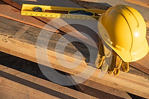 Abstract of Construction Hard Hat, Gloves and Level Resting on W