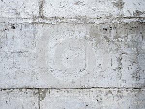 Abstract corrugated concrete wall texture background. Grey crack and broken cement tiles block wallpaper.
