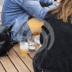 Abstract couple, a guy and a girl sitting drinking fresh dark and light beer