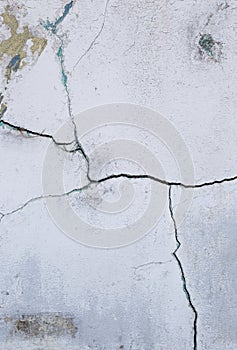 Abstract crack texture on old white paint cement wall, vertical style