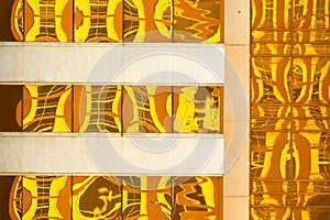 Abstract created by Golden yellow reflections on modern building