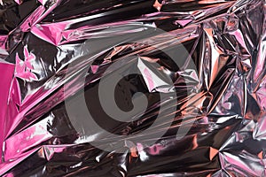 Abstract crumpled foil background. Grunge photo background. Pink and peach shadows