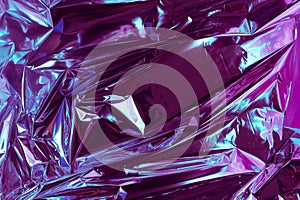 Abstract crumpled foil background. Grunge photo background. Neon colors. Blue and purple colors