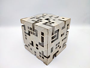 Abstract cube with random square holes pattern made out of cardboard