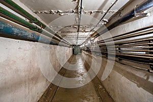 Abstract dark corridor of military bunker interior, grungy old underground tunnel. Nuclear shelter