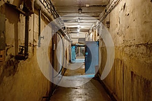 Abstract dark corridor of military bunker interior, grungy old underground tunnel. Nuclear shelter