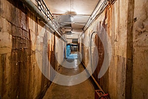 Abstract dark corridor of military bunker interior, grungy old underground tunnel. Nuclear shelter