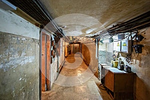 Abstract dark corridor of military bunker interior, grungy old underground tunnel. Nuclear shelter