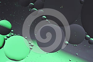 Abstract dark gray green background with oil circles water surface.