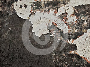 Abstract Dark Grunge wall texture background. Paint cracking off dark wall with rust underneath.distressed crackled texture.