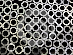 Abstract dark industrial background of sawed steel pipes ends - flat and full frame