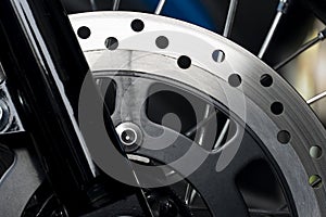 Abstract dark tone beside veiw of Disc Brake of motorcycle.