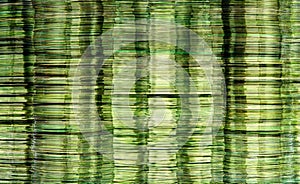 Abstract data storage image with layered stacks of translucent metallic green DVD and CD computer storage disks