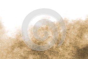 Abstract deep brown dust explosion on white background.Freeze motion of brown dust splash