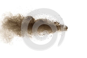 Abstract deep brown dust explosion on white background.  Freeze motion of coffee liked color dust splash