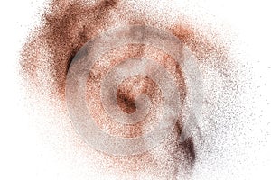 Abstract deep brown dust explosion on white background. Freeze motion of coffee liked color dust splash