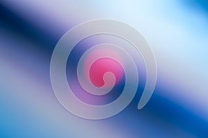 Abstract defocused blue background with bright pink spot in the center