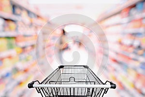 Abstract Defocused Blurred of Consumer Goods and Shopping Cart in Supermarket Store, Shop Trolley Basket in Department Store.