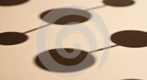 Abstract design featuring a pattern of interconnected black circles on a beige