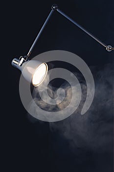 Abstract desk lamp in smoke, copy-space background