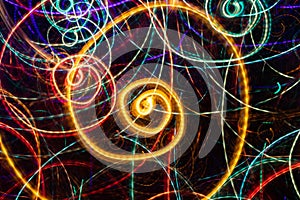 Abstract drawing of glowing multicolored spiral swirls on black background