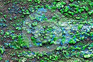 Abstract dried green and blue paint on sand paper