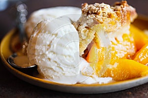 Abstract of Drop Biscuit Peach Cobbler with Ice Cream photo