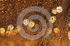 Abstract drops of rain on glass brown and orange colors