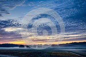 Abstract early morning sunrise over farm land