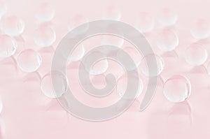 Abstract elegant gentle festive pink background with transparent glass balls, texture, blur.