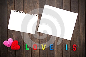 Abstract empty note with Red and Pink Heart Knitting on wood background. valentine greeting card copy space for add text message.