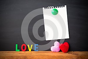 Abstract empty paper note with Red and Pink Heart Knitting on blackboard background. valentine greeting card copy space for add