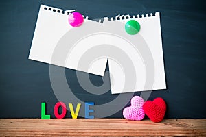 Abstract empty paper note with Red and Pink Heart Knitting on blackboard background. valentine greeting card copy space for add