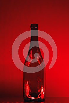 Abstract empty wine bottle with red led illumination