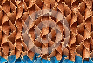 Abstract, The evaporative-cooling-pad paper image shows a close-up view of a rough, textured surface made up of overlapping and