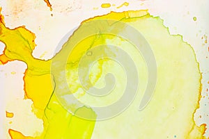 Abstract expansion of yellow and orange colors of watercolor