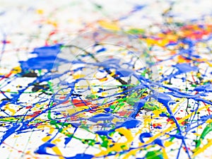 Abstract expressionism art creative background. art of splashes and drips . red black green yellow blue paint on white background