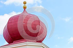 Abstract exterior view of the top of the roof of the old castle. Blue sky in the background. Superior part of the tower.