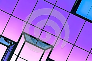 Abstract fantasy glass background with neon purple texture. Modern geometric futuristic architecture in the city in an