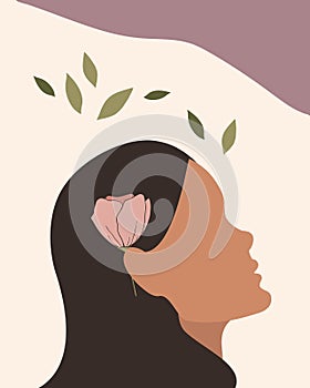 Abstract female profile with flower. Hand drawn female face silhouette with a pink flower in her hair. Minimal design
