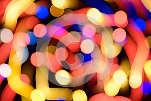 Abstract festive background with photo realistic bokeh defocused lights. Christmas atmosphere shining into the space.