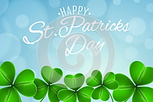 Abstract festive background for Saint Patrick`s Day. Clovers of shamrocks on a blue background with glares bokeh. Calligraphic wh