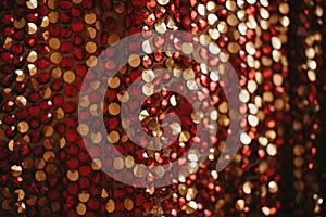 Abstract festive red and golden background of sparkle confetti circles. Holiday greeting card