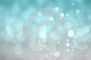 Abstract festive turquoise silver shining glitter background texture with blurred bokeh circles and white lights. Space for design