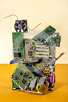 Abstract figure folded from computer circuit boards on a colored background