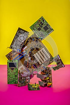 Abstract figure folded from computer circuit boards on a colored background