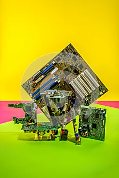 Abstract figure folded from computer circuit boards on a colored background