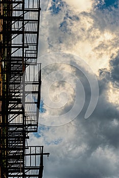 Abstract Fire escape silhouette and cloudy skies