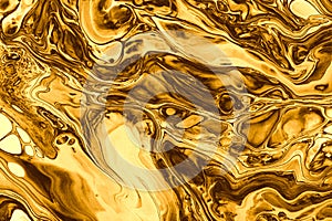 Abstract flow gold and bronze pour flow marble blot wave. Color copy space smoke horizontal texture background