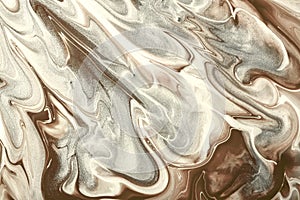 Abstract fluid art background beige and silver colors. Liquid marble. Acrylic painting with gray gradient